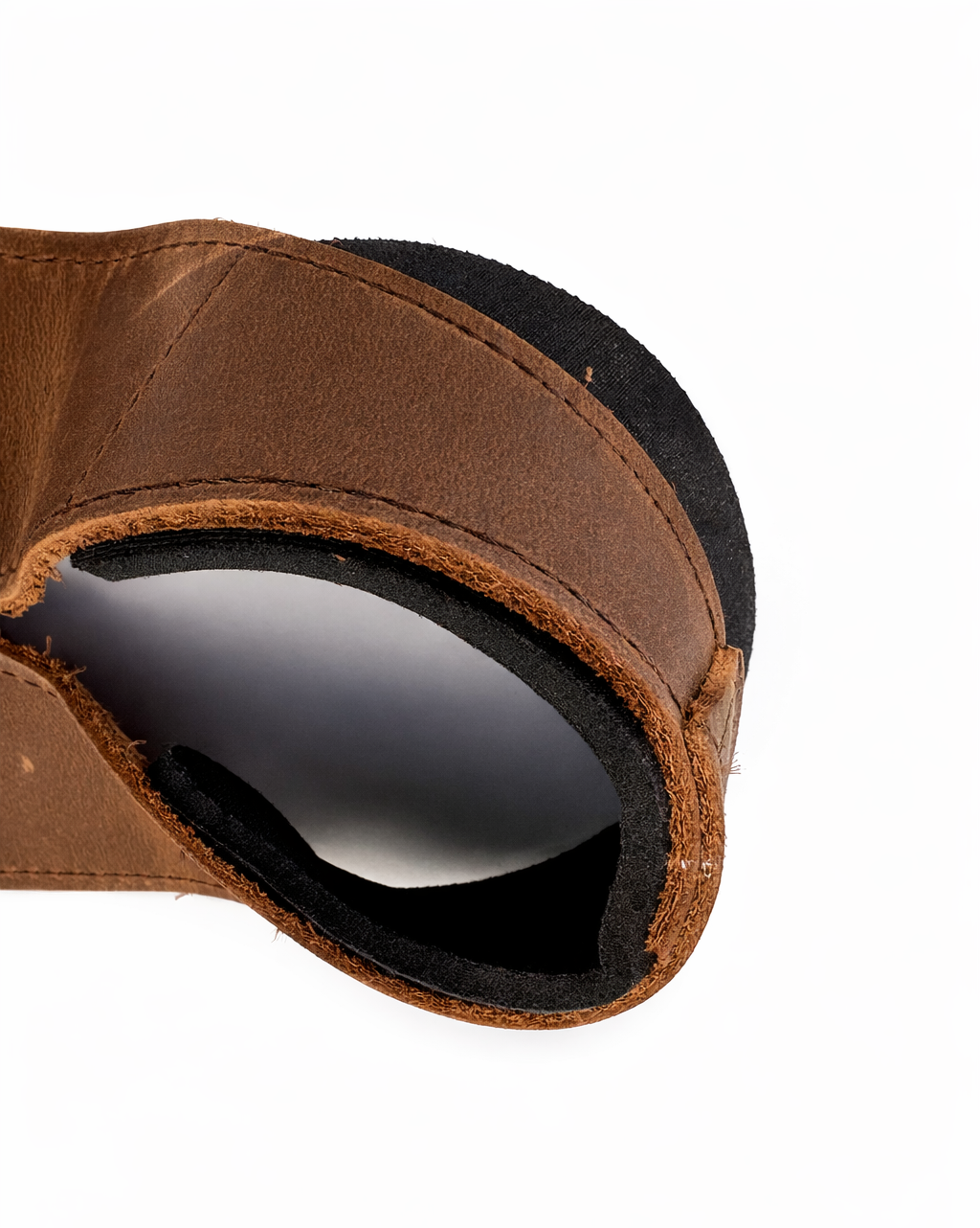 Close-up of a brown leather lifting strap detail shot on a white background