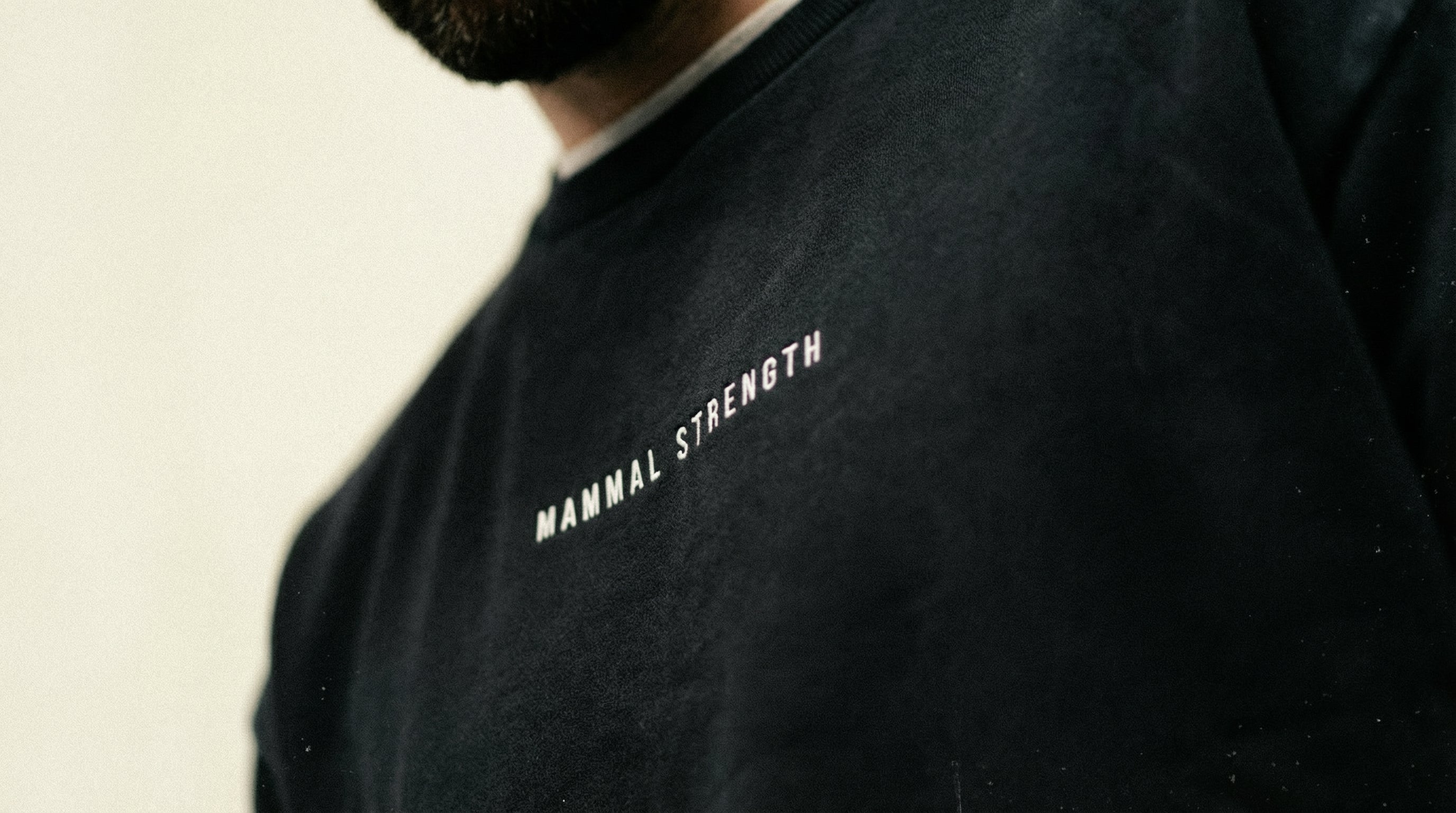 Mammal Strength black training sweatshirt with minimalist logo – premium gym and weightlifting apparel