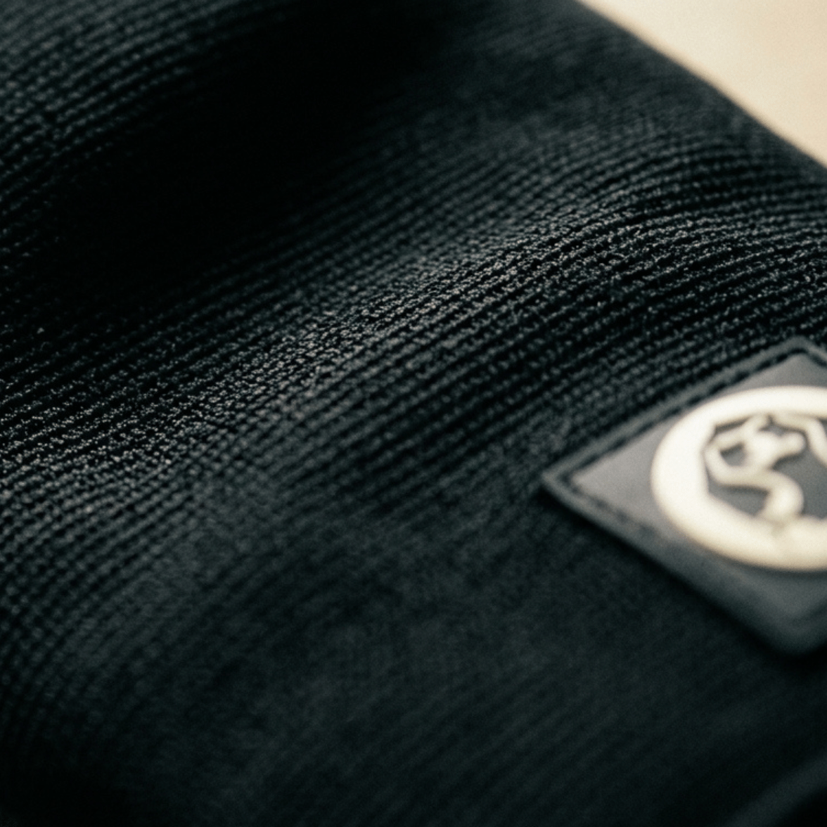 Close up of Mammal Strength 3mm double ply knee sleeves showing compression fabric texture and logo